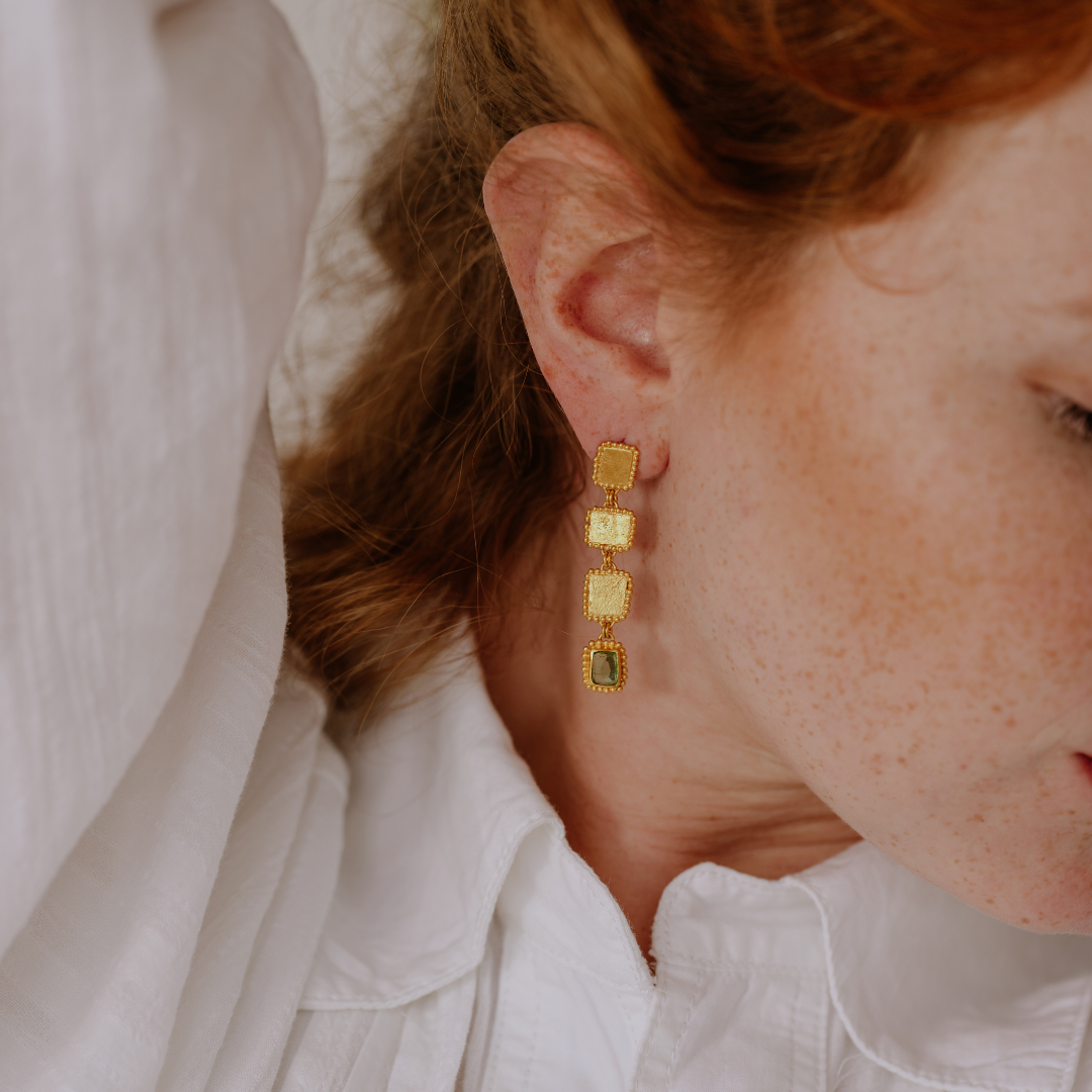 Indulge in the allure of these one-of-a-kind earrings, boasting organic textures and striking green gemstones.