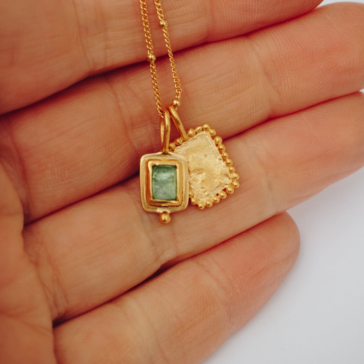 Square gold pendant adorned with a captivating blue rose cut tourmaline
