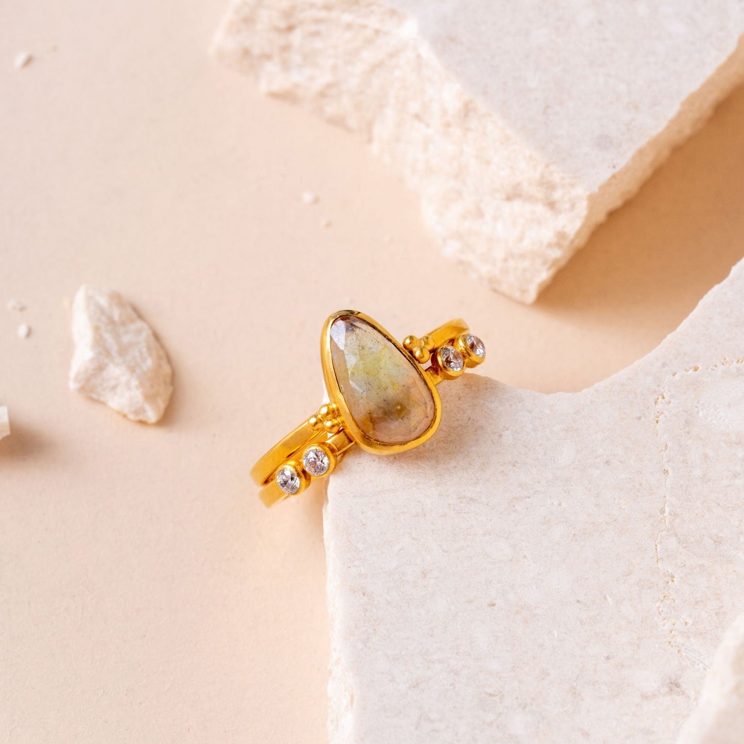 Handcrafted gold ring featuring a luminous teardrop sapphire and finely crafted granulation elements.