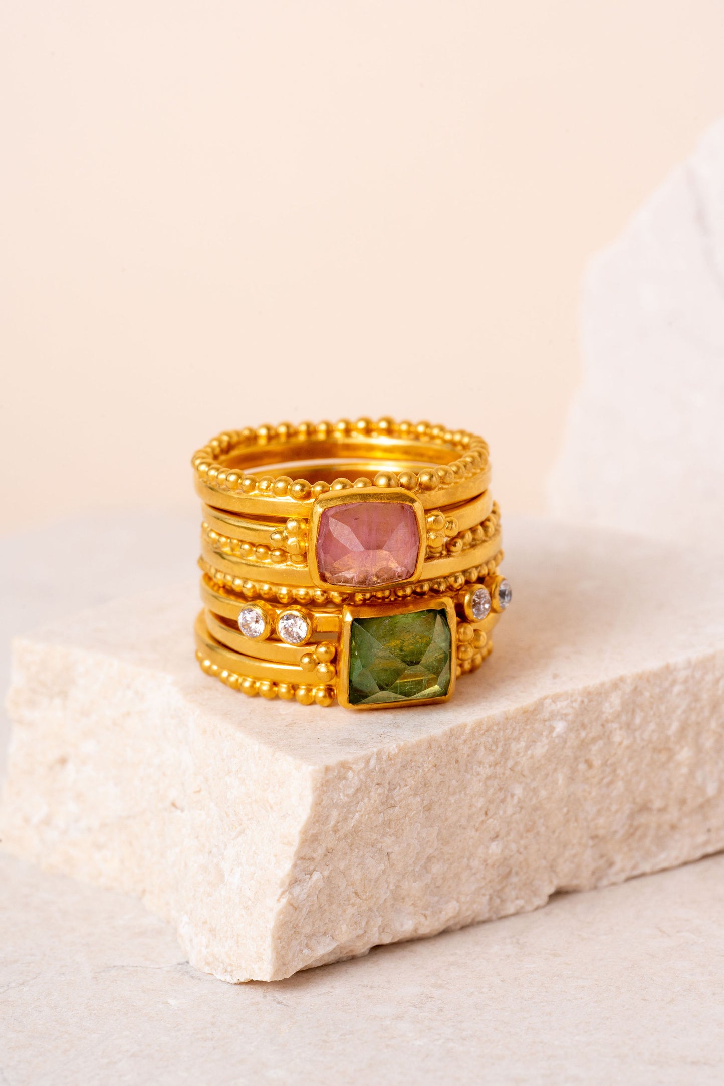 Artisan gold ring showcased in a stack of gemstone and granulation rings.