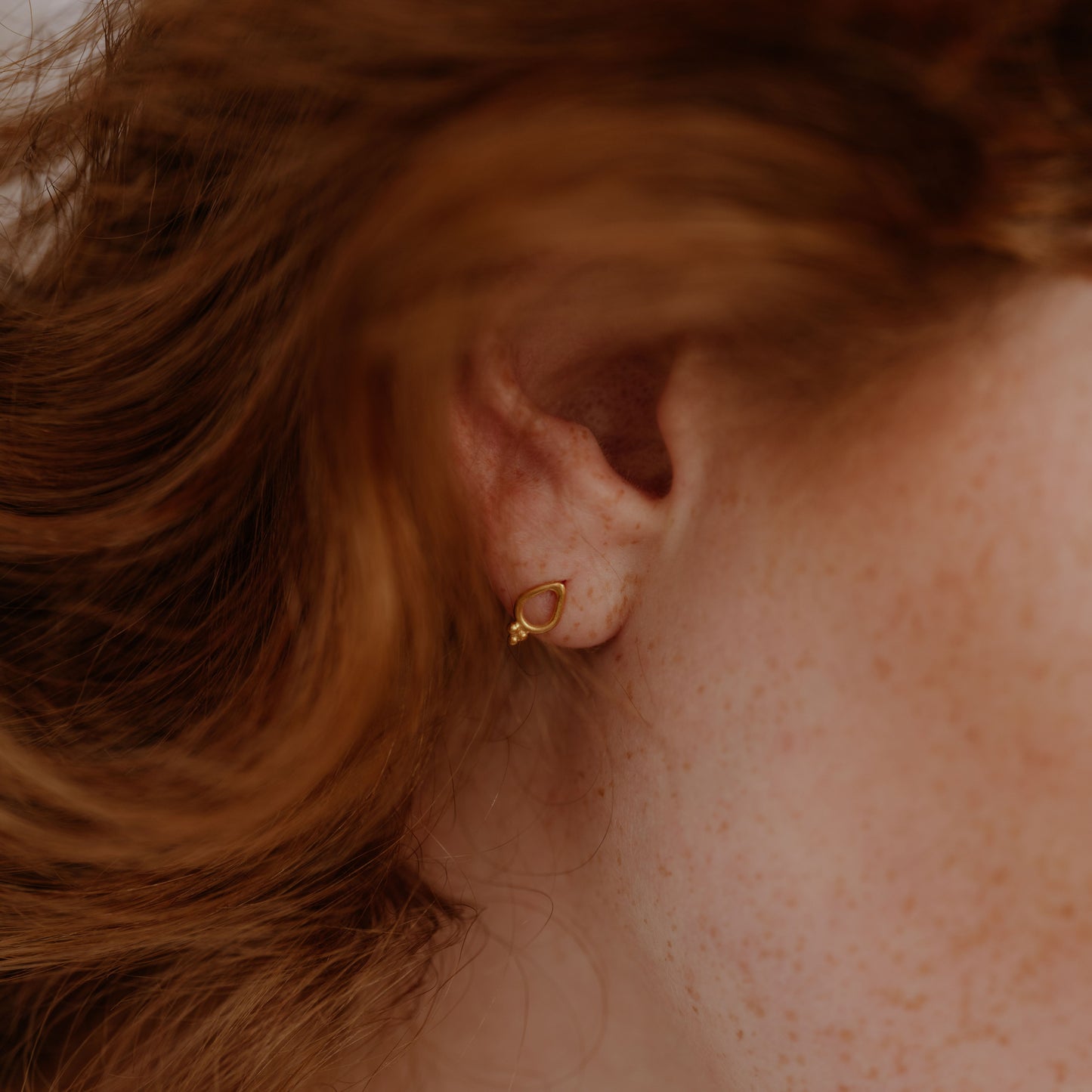Petite gold studs with intricate granulation