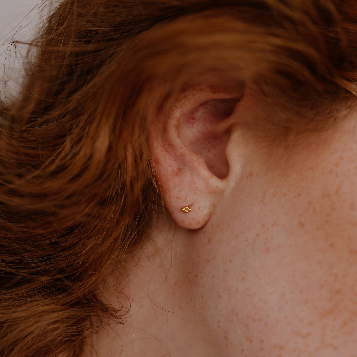 Petite gold studs with intricate detailing