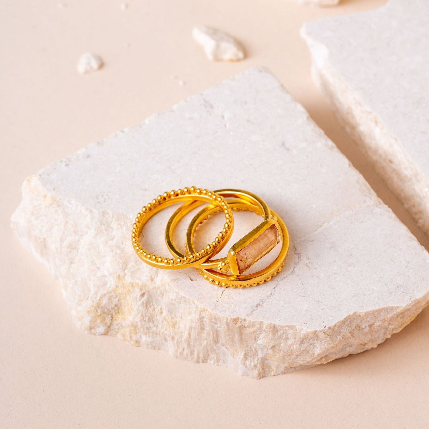 Group of artisan gold rings, including one with a unique rectangular tourmaline.