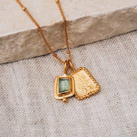 Square gold pendant with a mesmerizing blue rose cut tourmaline gemstone and intricate granulation detail on a delicate satellite chain.