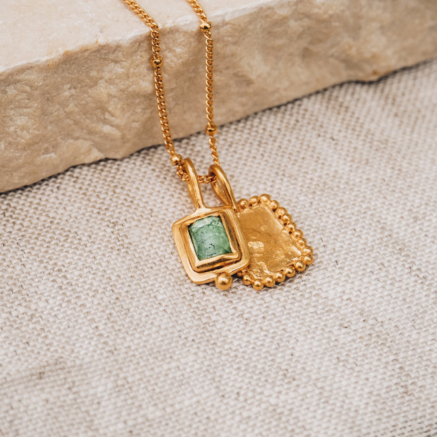 Exquisite square gold pendant with a breathtaking blue rose cut tourmaline gemstone and delicate granulation, suspended elegantly from a fine satellite chain.