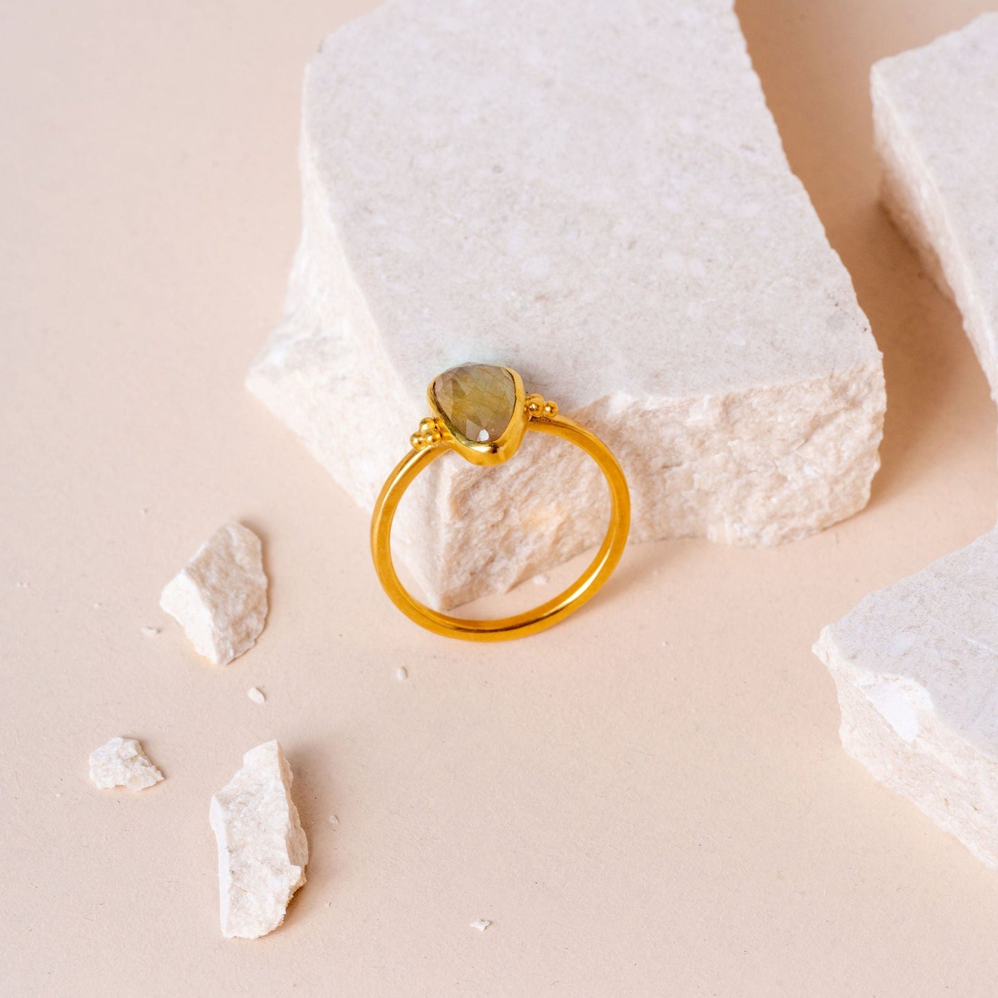 Artisan ring showcasing a light yellow teardrop sapphire and meticulous granulation craftsmanship.