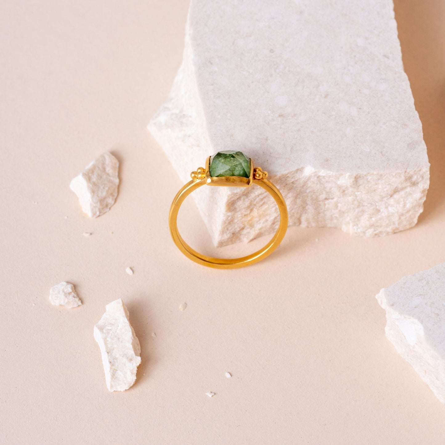 Artisan gold ring with delicate granulation patterns, highlighting a unique green rose-cut square tourmaline centrepiece