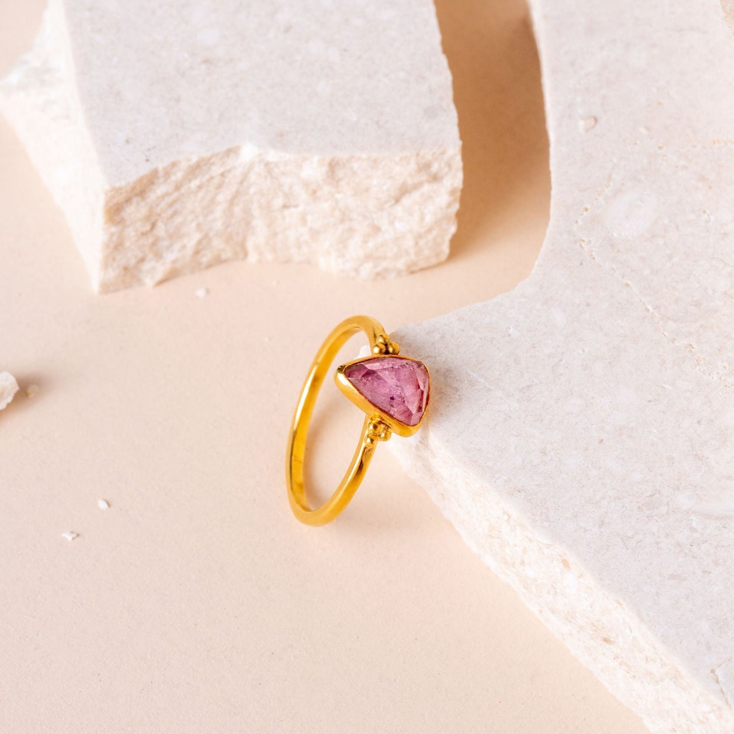 Elegant gold ring featuring a lovely pink tourmaline gem, crafted with precision and unique granulation details.