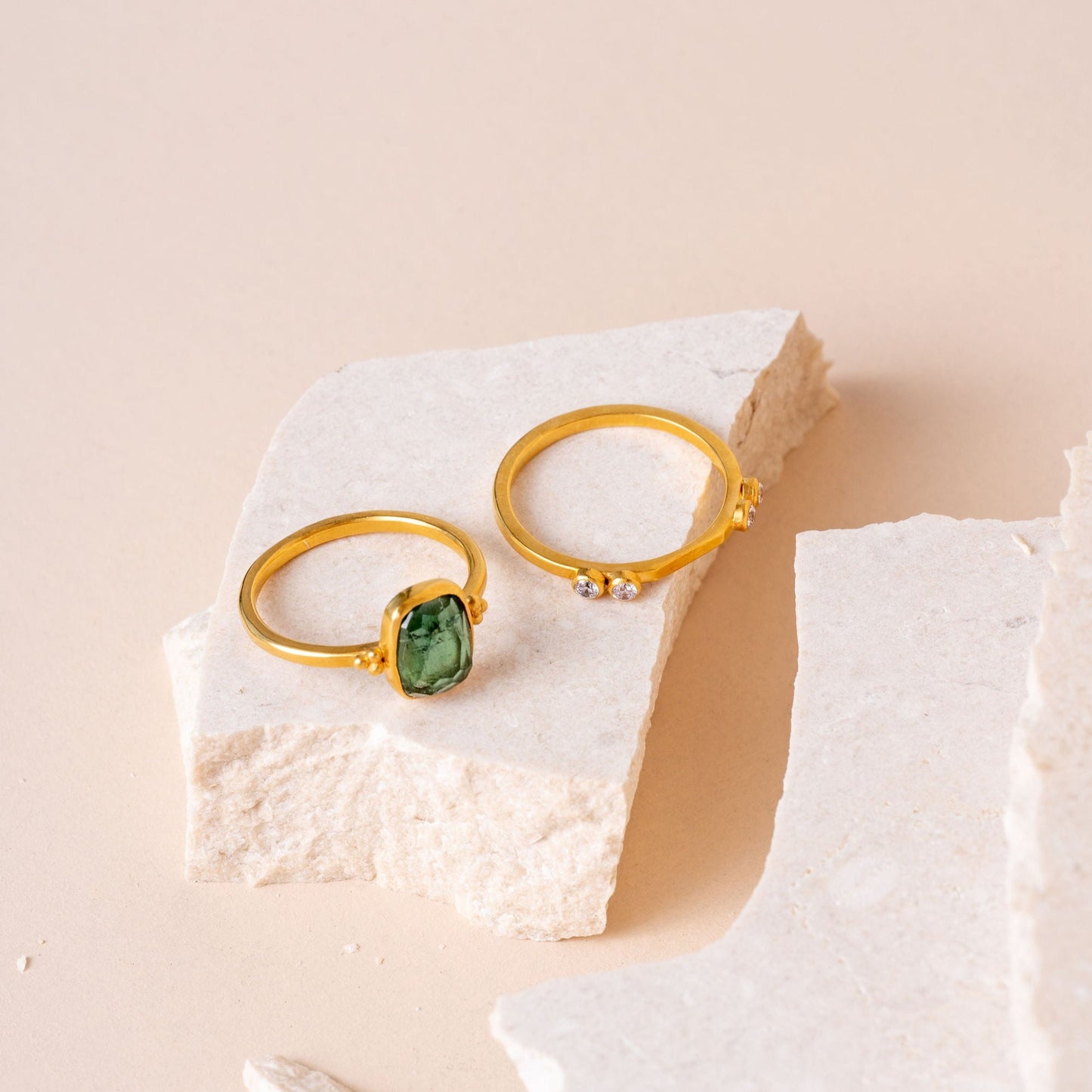Group shot of exquisite gold rings, each adorned with meticulous granulation and complemented by the allure of green tourmaline gemstones