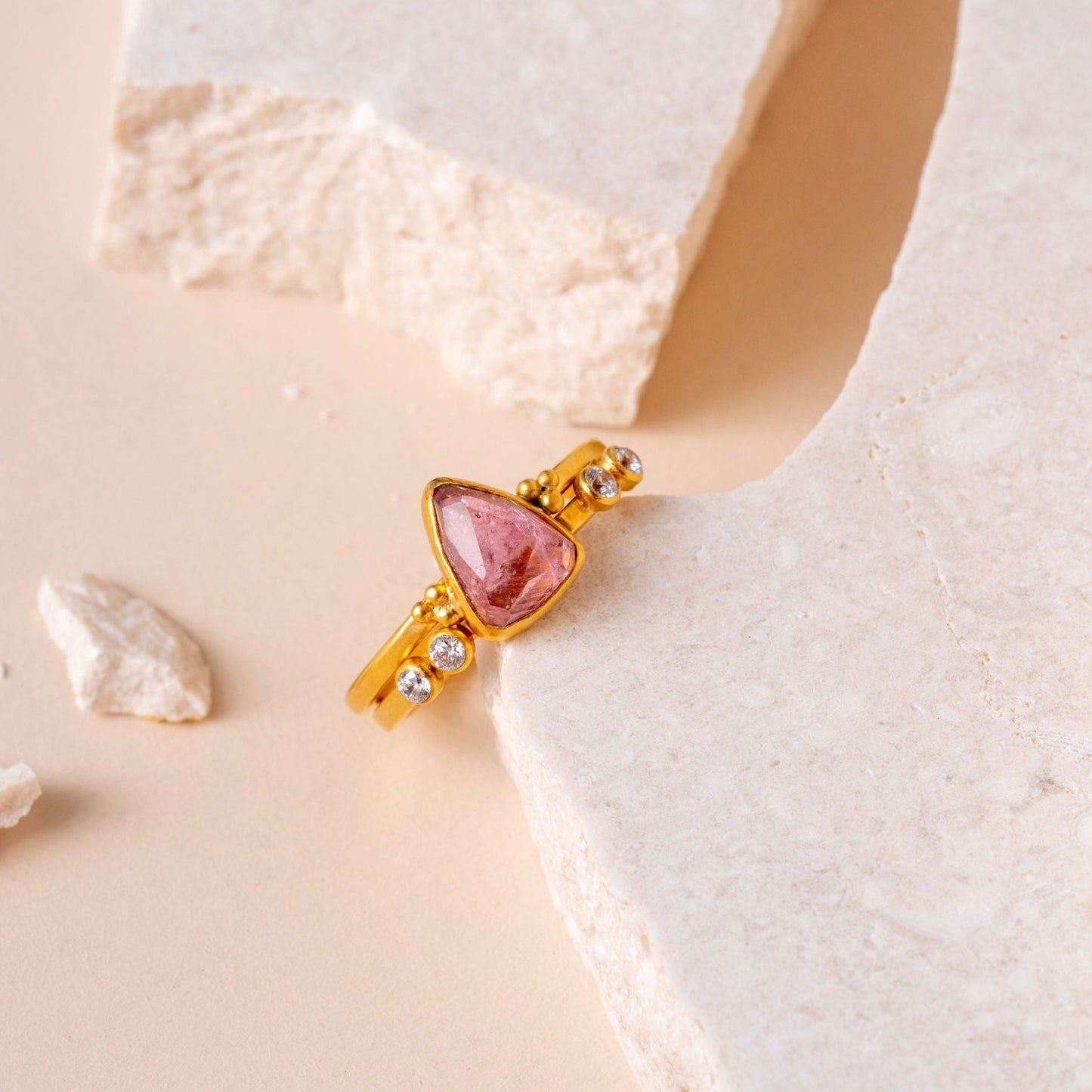 Artisan made gold ring, featuring a hand-cut pink tourmaline gem and intricate granulation for a look of refined elegance.