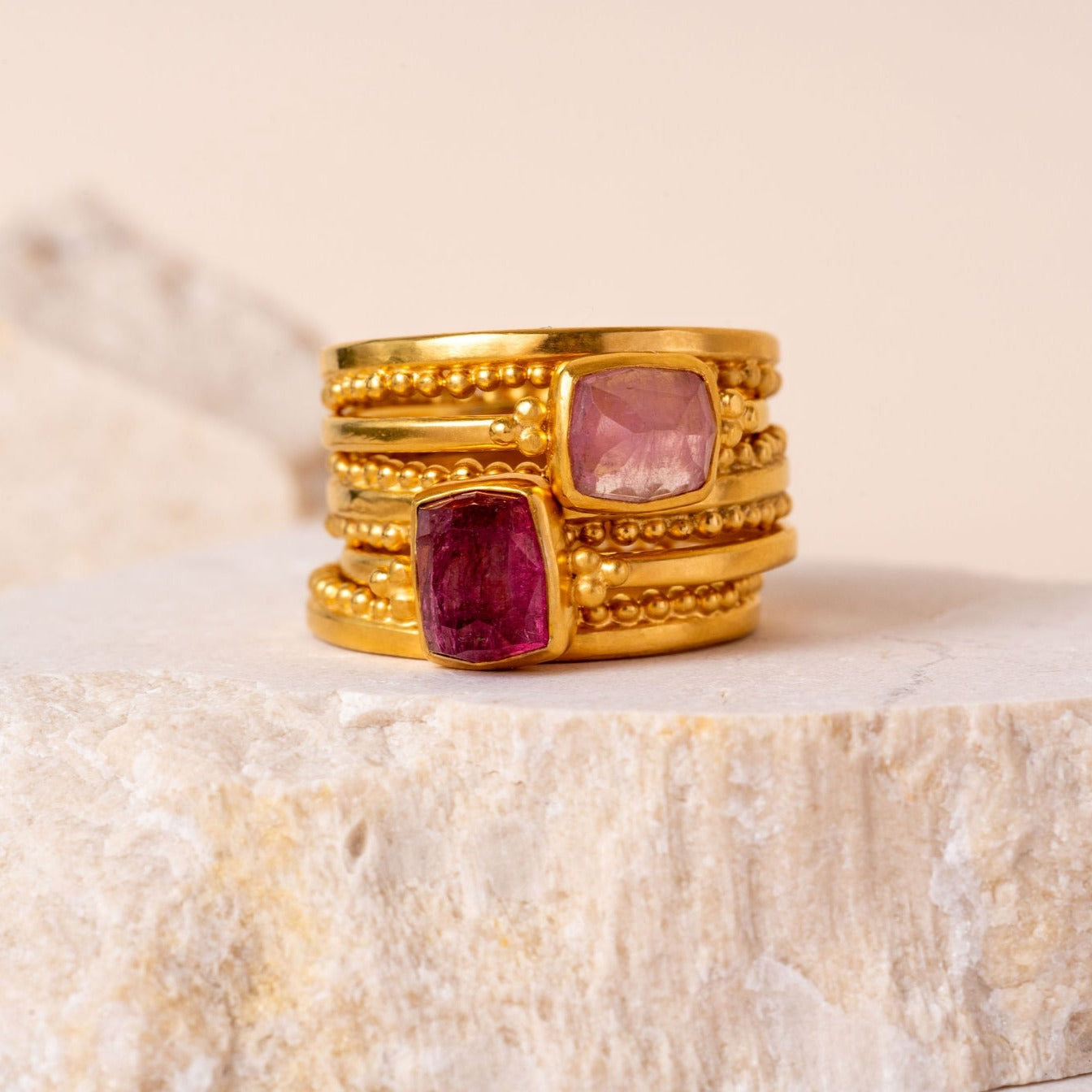 Gold ring stack showcasing brilliant pink rose-cut tourmaline and rich 24 carat vermeil.