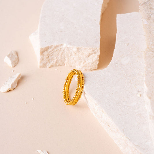 Artisan-crafted gold ring with intricate granulation detailing.