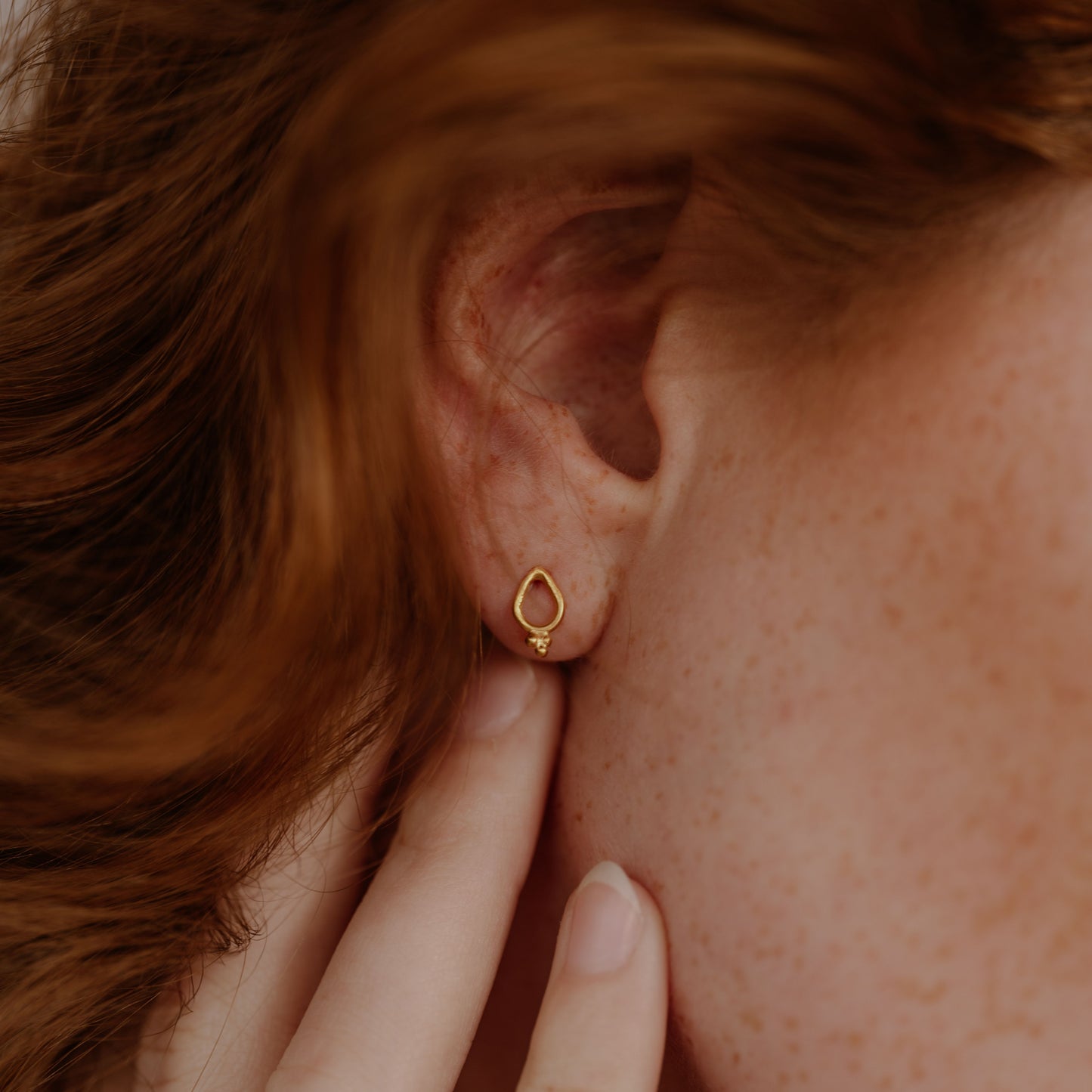 Artisan gold earrings, delicate stud design