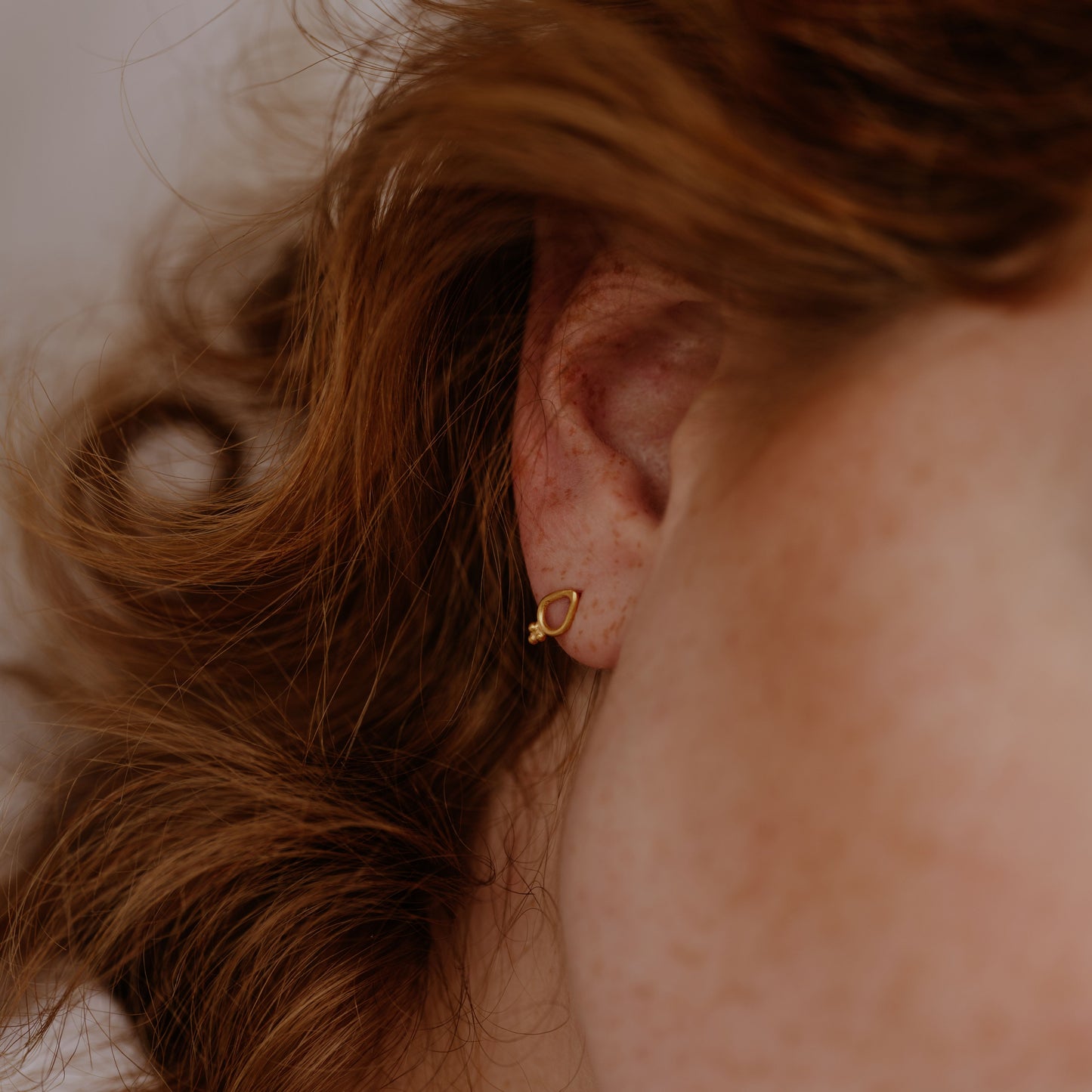 Tiny gold studs crafted with granulation
