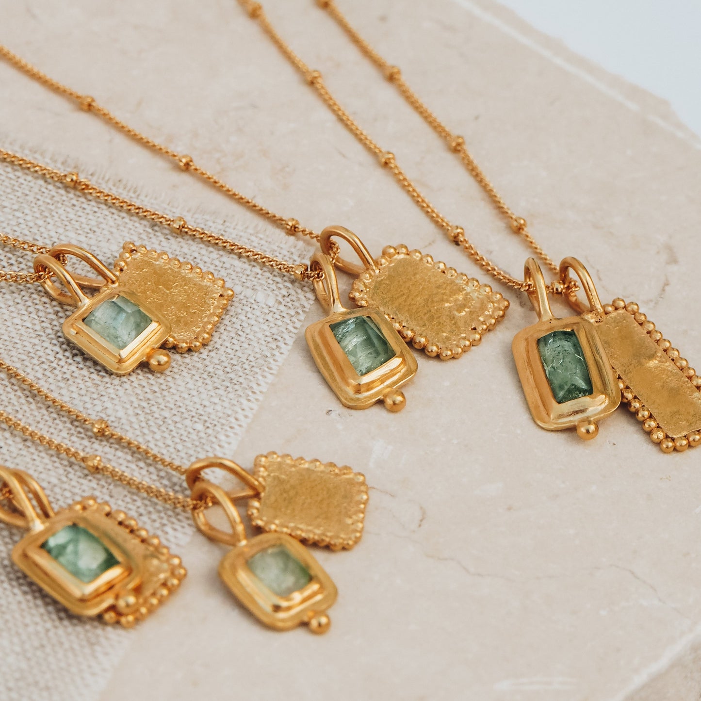 A collection of granulated pendants with blue tourmaline gemstones