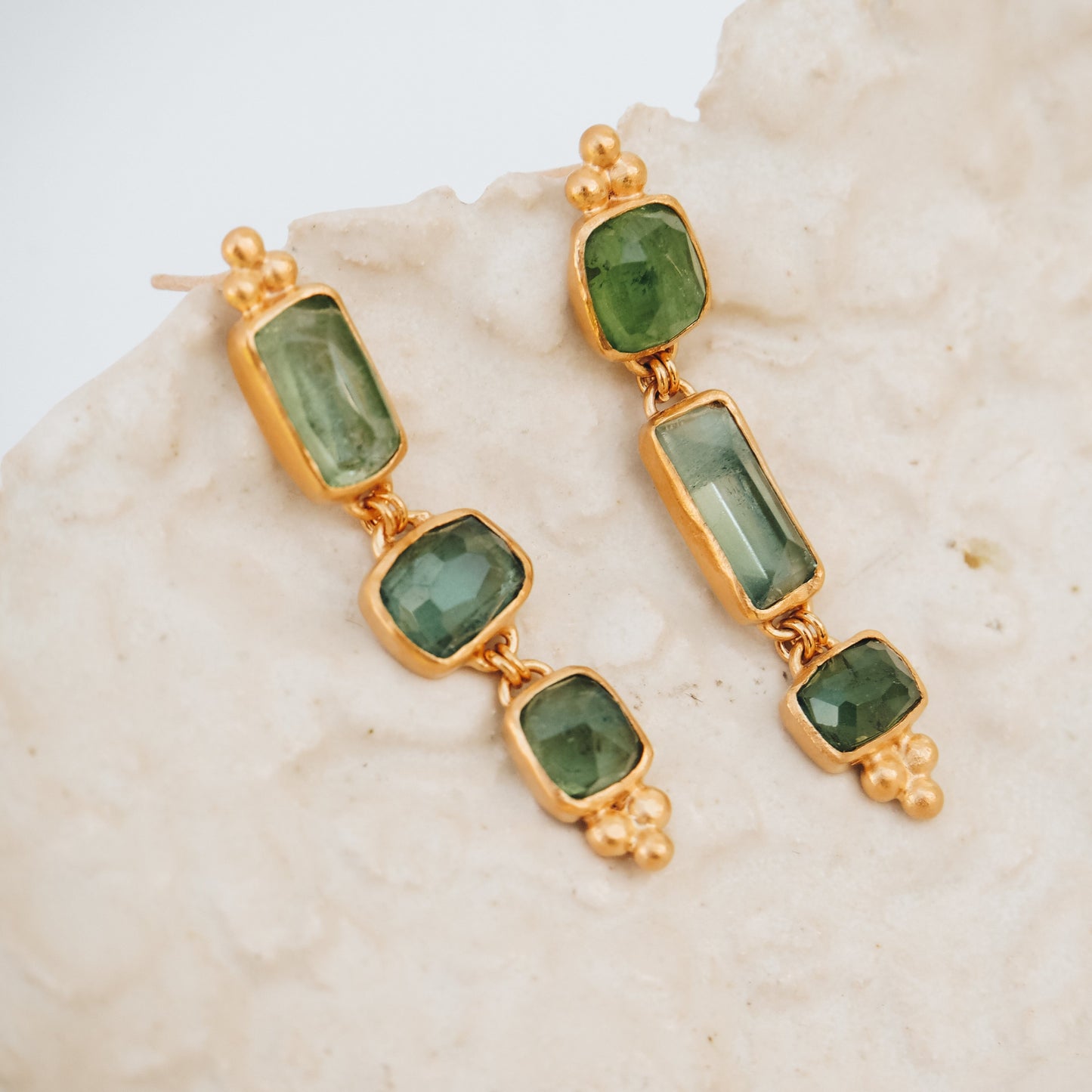 Unique gold drop earrings with square rose cut tourmaline gemstones in ocean blue and green, enhanced with granulation detailing.
