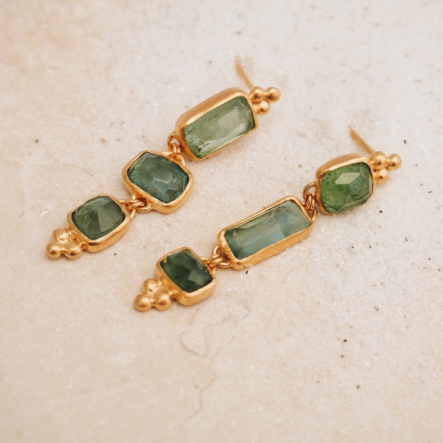 Dainty gold earrings with square rose cut tourmaline gemstone drops in ocean blue and green, embellished with stunning granulation detail