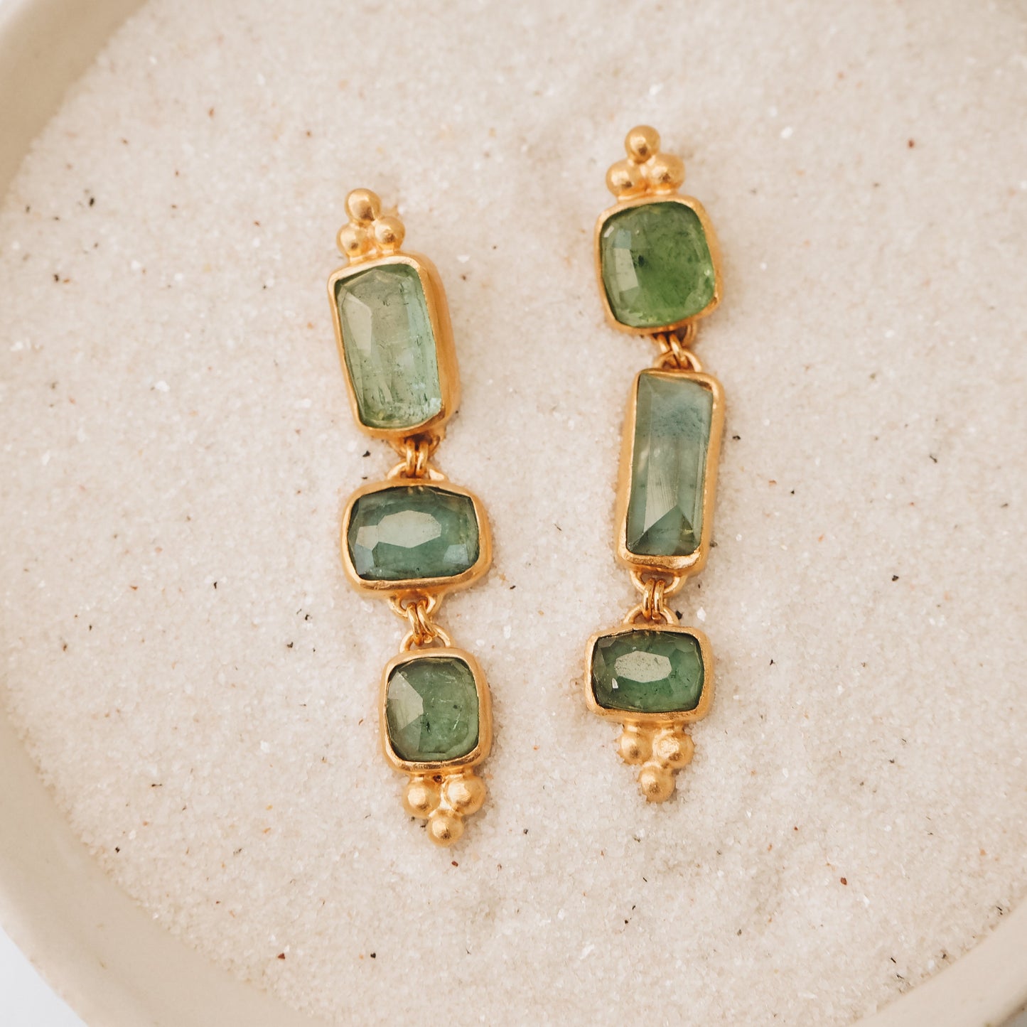 Exquisite gold earrings showcasing square rose cut tourmaline gemstone drops in ocean blue and green, accentuated by meticulous granulation details