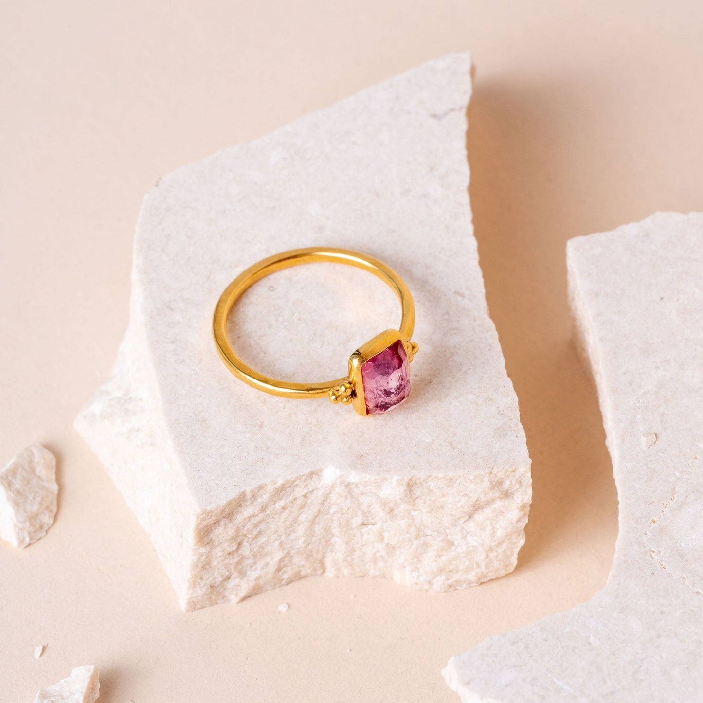 Handcrafted gold ring adorned with a delicate pink tourmaline and dainty granulation.