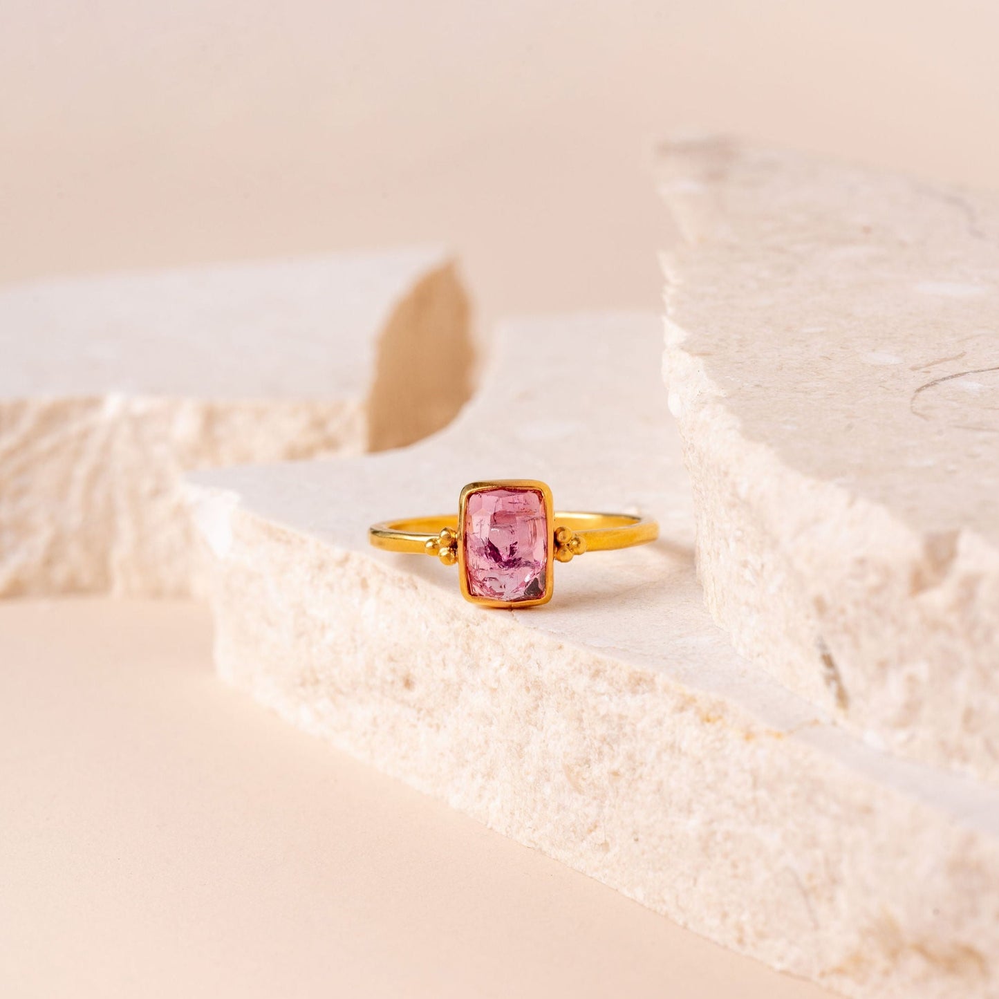 Artisanal ring design showcasing a stunning hand-cut pink tourmaline with delicate granulation.