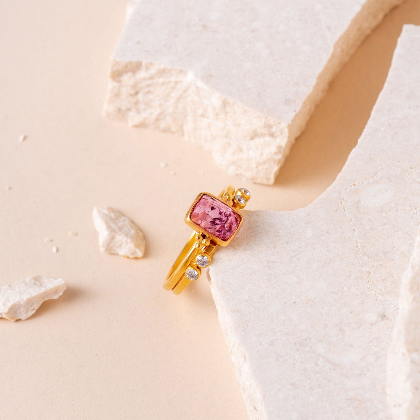 Handcrafted gold ring adorned with an exquisite pink tourmaline and fine granulation detailing.