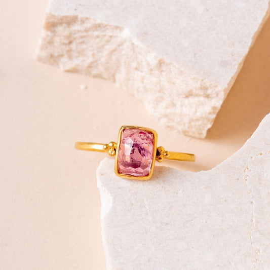 Artisan gold ring featuring a hand-cut pink tourmaline and intricate granulation details.