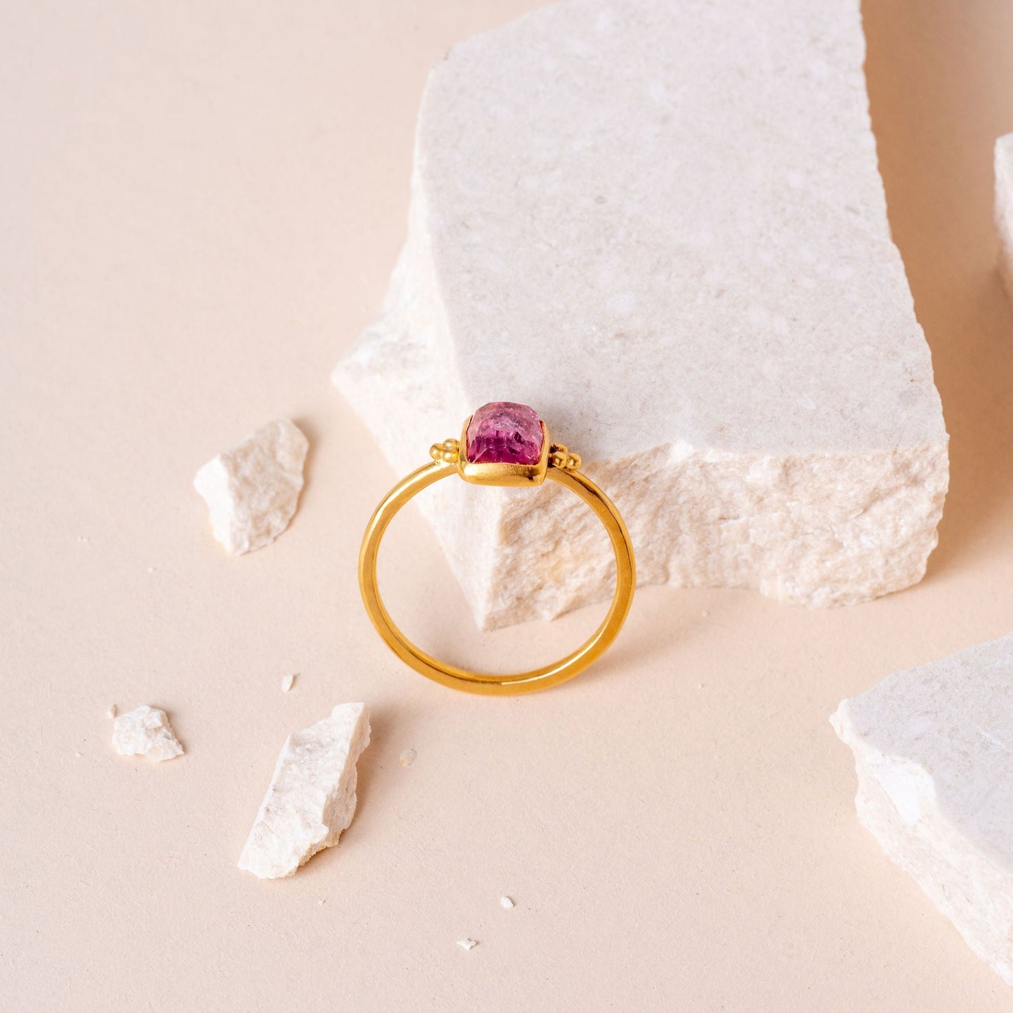 Artisan gold ring featuring granulation detailing surrounding a beautiful hand-cut pink tourmaline.