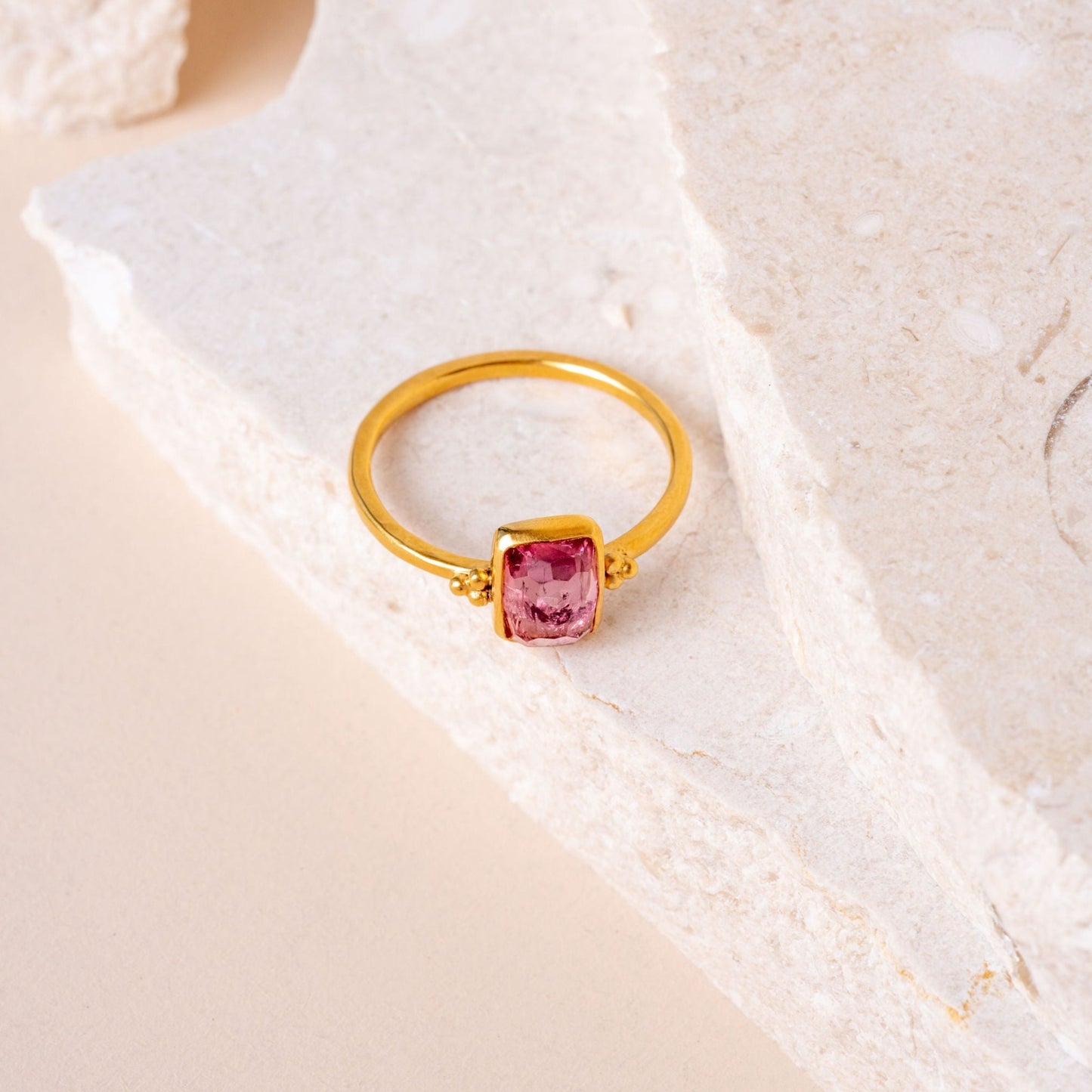 Handcrafted gold vermeil ring with meticulous granulation details framing a stunning hand-cut pink tourmaline