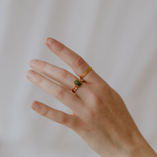 Artisan-made gold ring featuring intricate granulation detail.