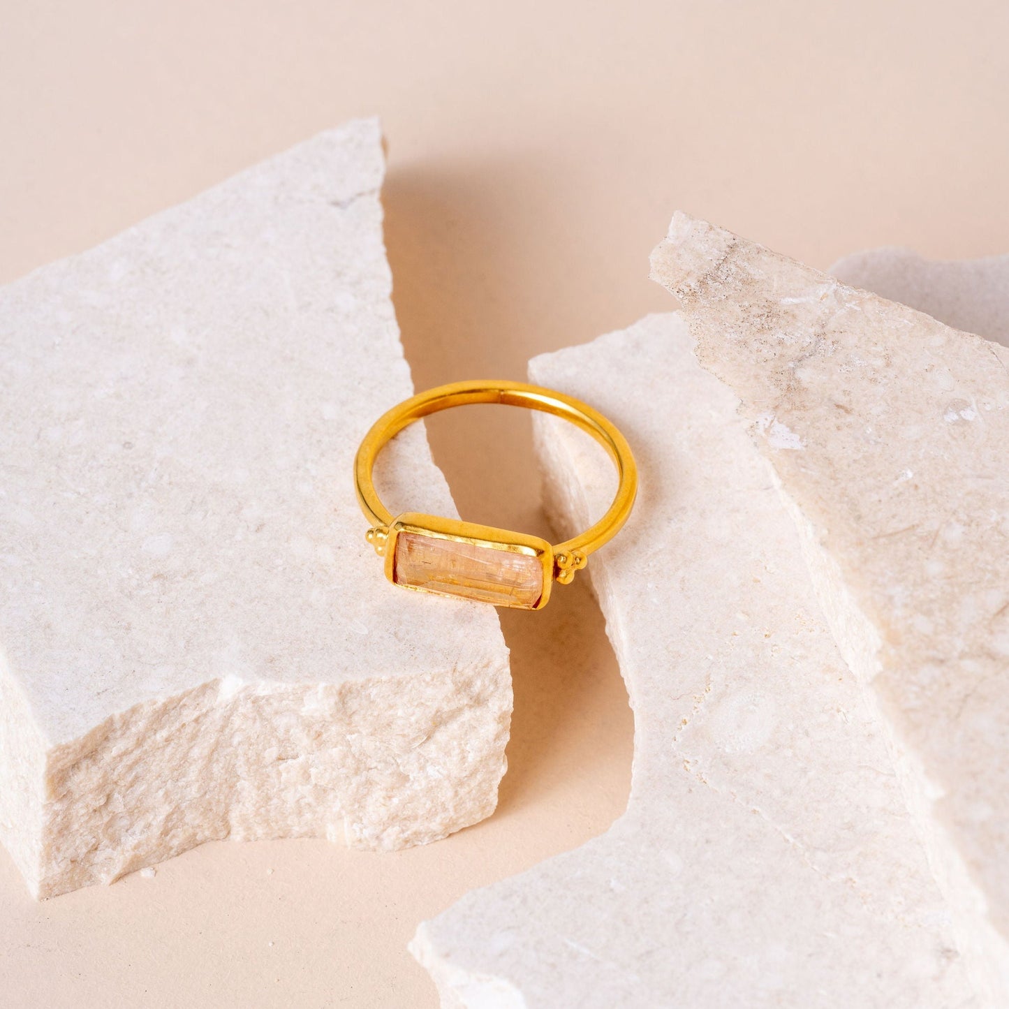 Distinctive artisan ring with granulation detail and a yellow gemstone.