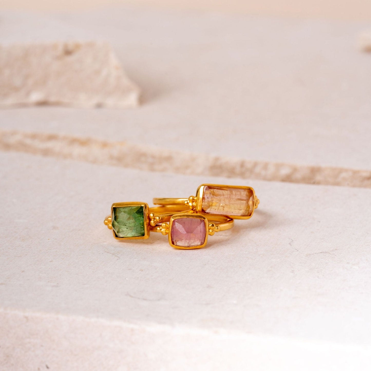 Handcrafted gold ring collection featuring a standout rectangular tourmaline design.