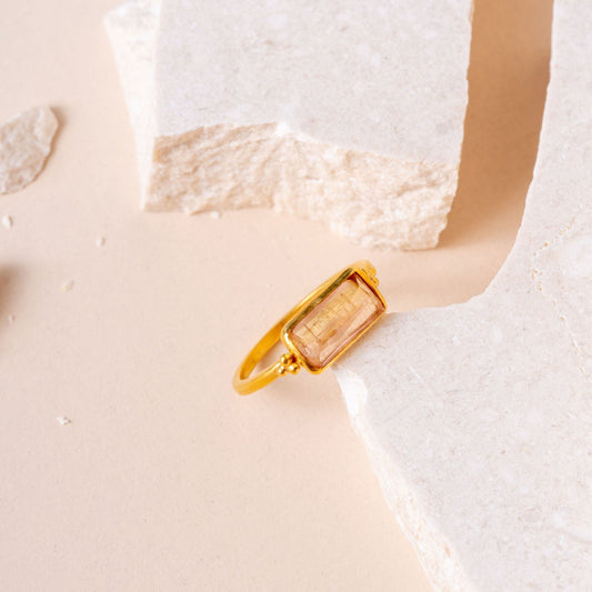 Artisan-crafted gold ring featuring a sunset-hued rectangular tourmaline.