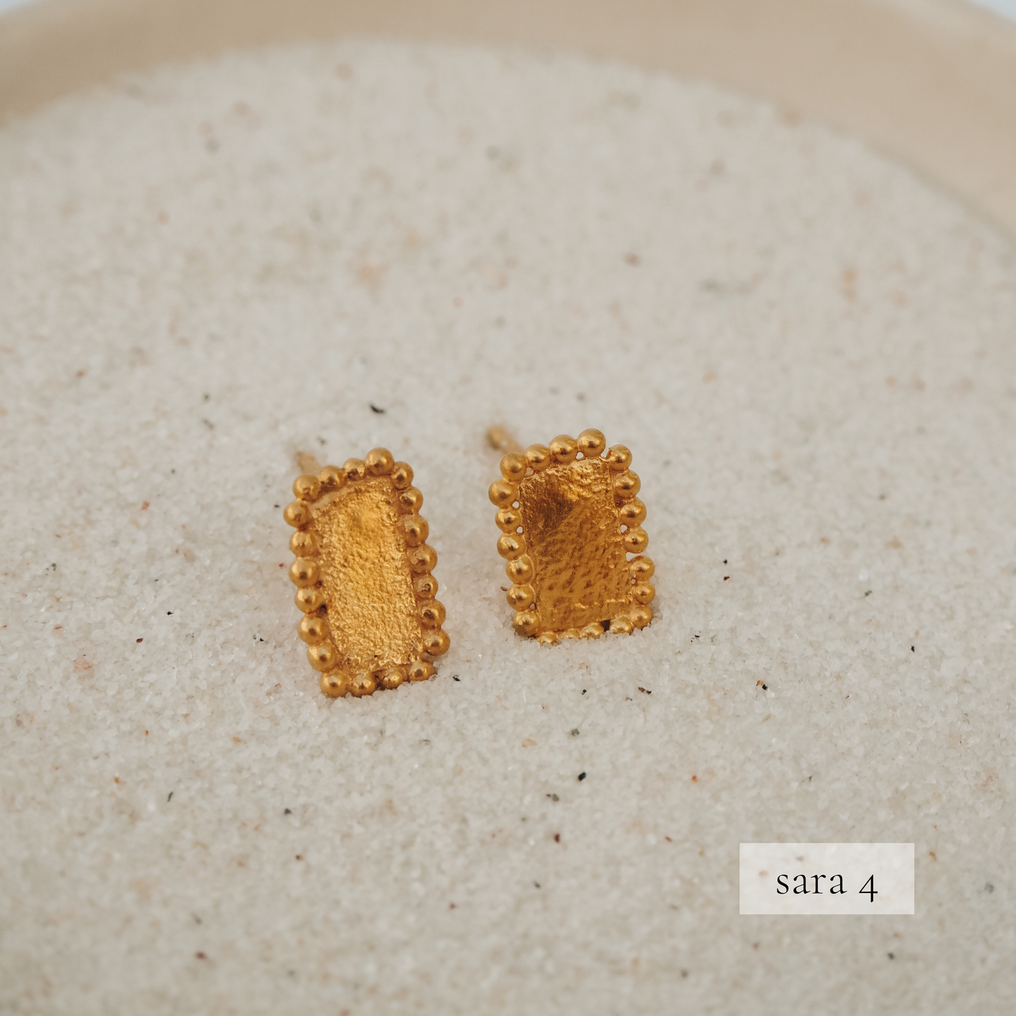 Gold stud earrings with square-shaped design and intricate granulated texture