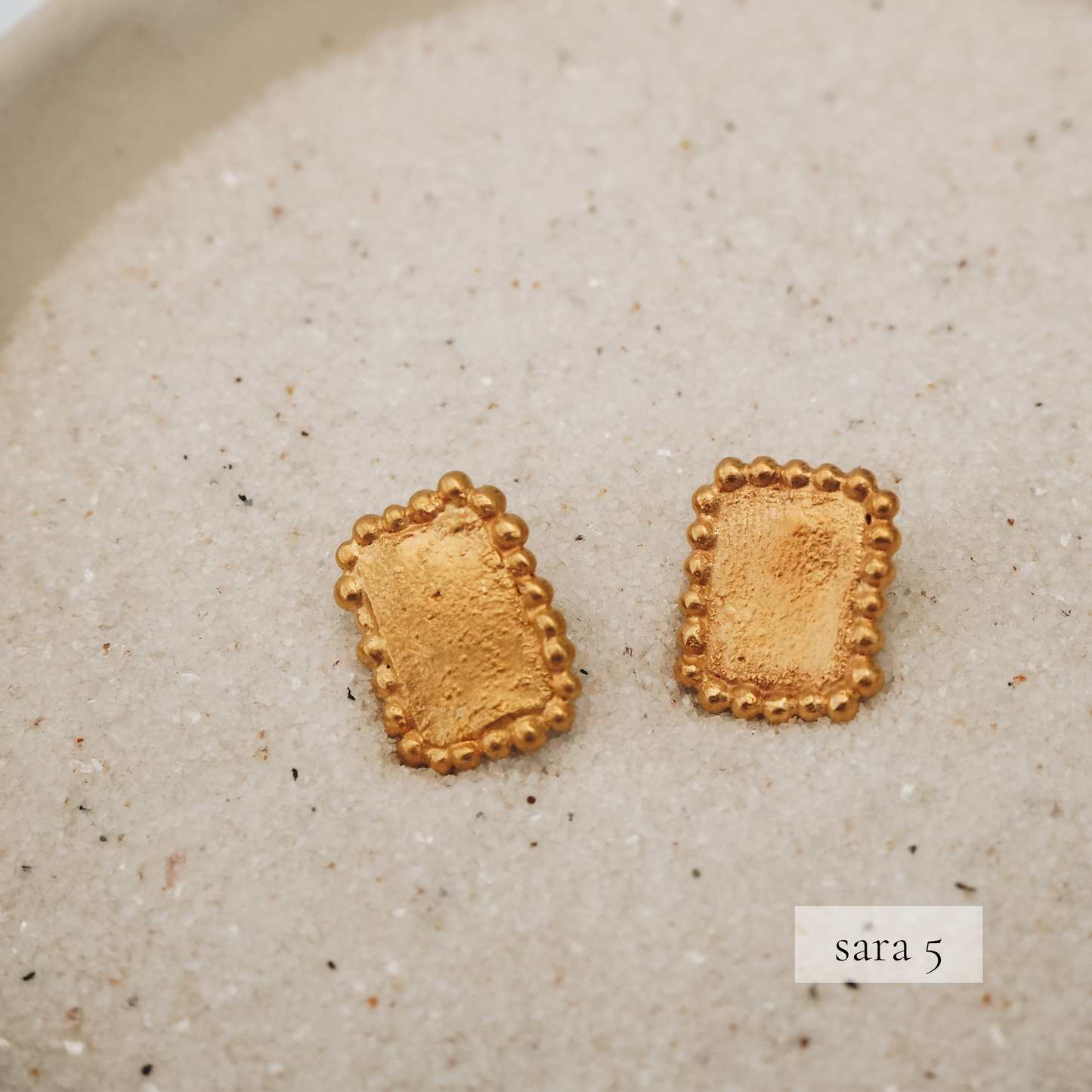 Dainty square earrings featuring granulation and a rich gold finish
